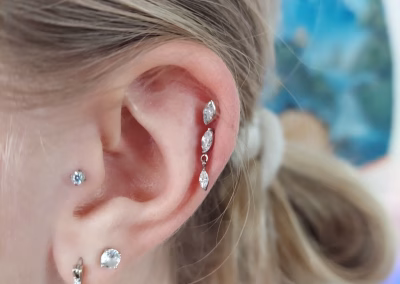 How should I clean a new piercing?