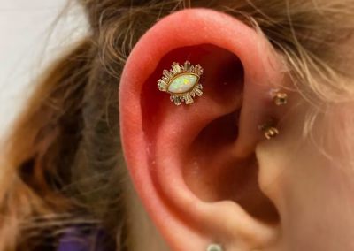 How should I clean a new piercing?